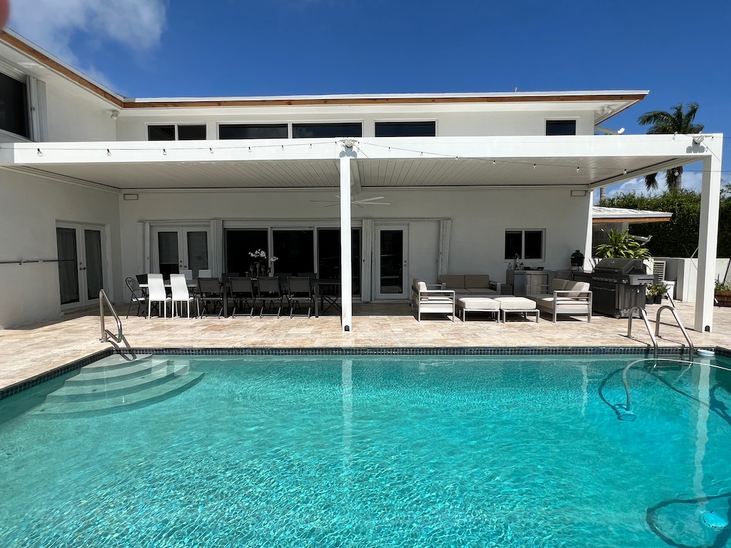 Contemporary pergola placed next to a modern backyard pool