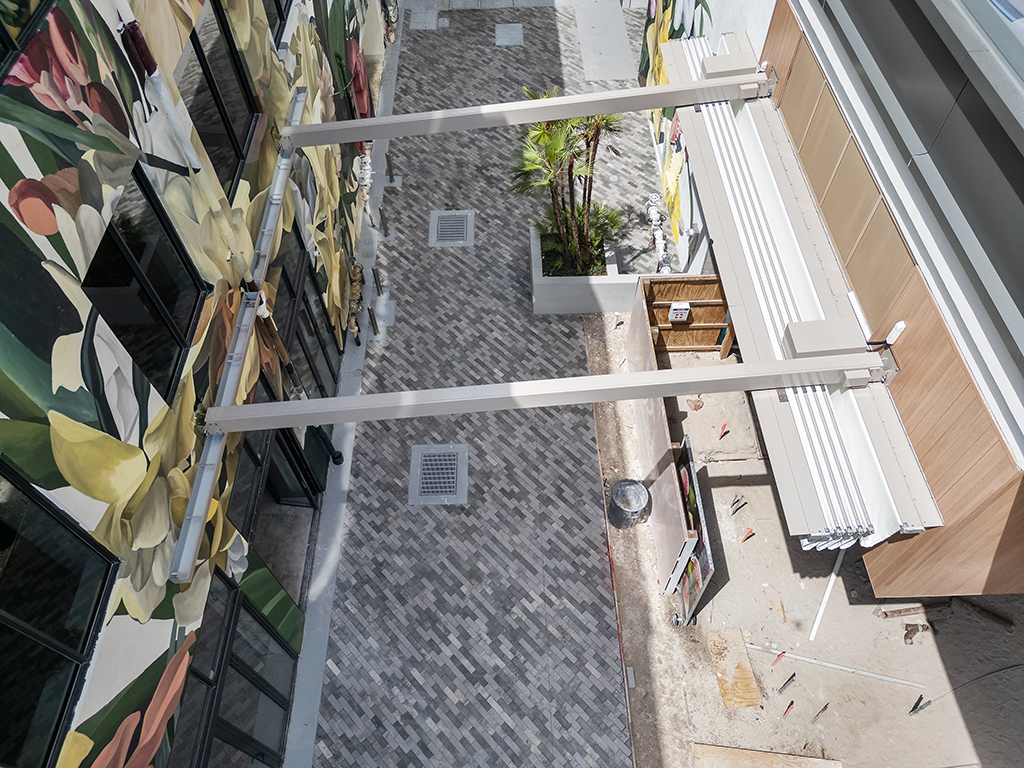 Retractable En-Fold awning system connecting Avli dining space and kitchen