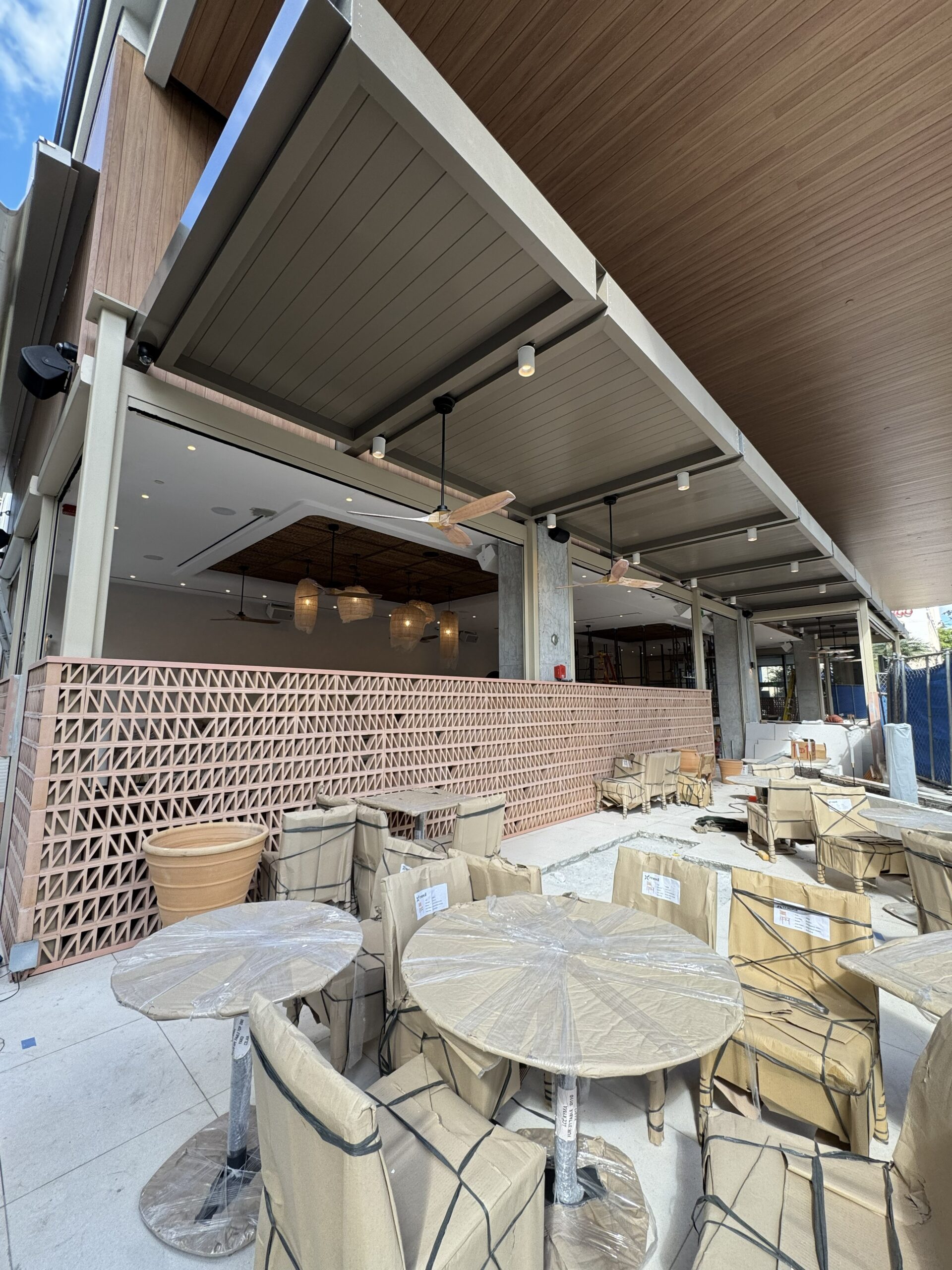 Cantilevered aluminum canopy and retractable awning at Avli ground floor dining area