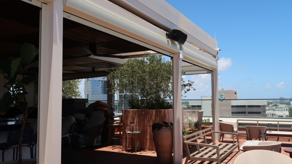 Hurricane MagnaTrack screens installed around rooftop louver systems
