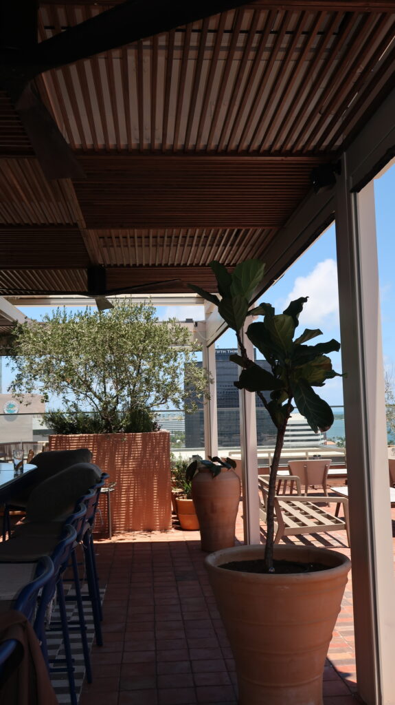 Rotating louver roof system with open-span dining area at Tarrazza