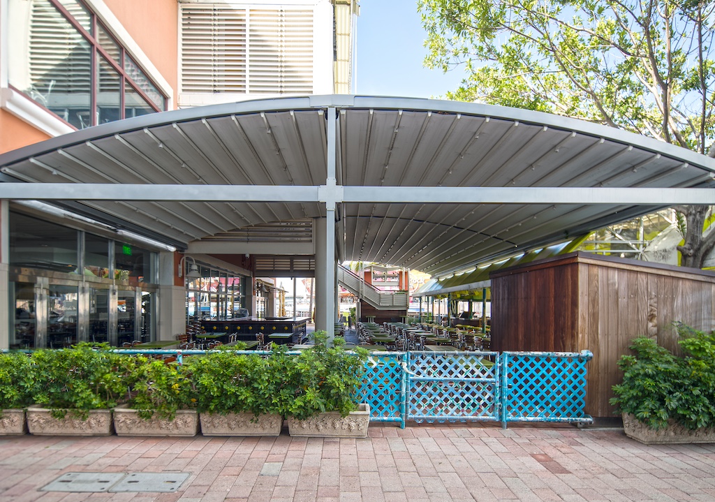 Modern pergola designed to provide shade for a seating area.