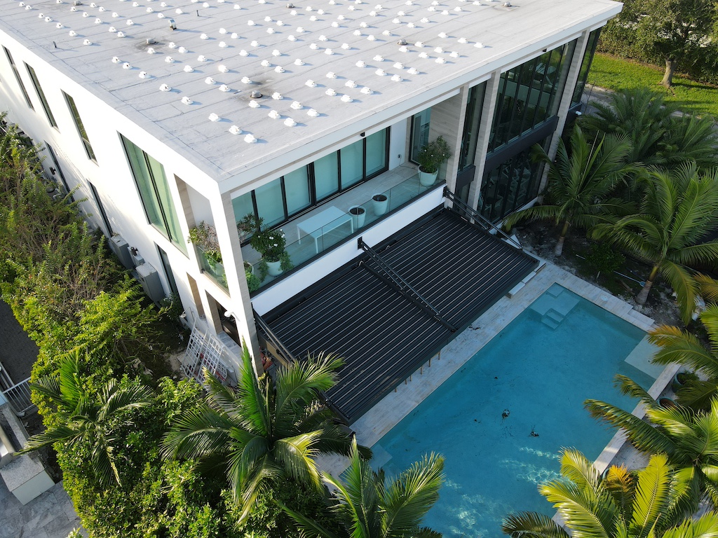 Pergola structure beside pool creating comfortable outdoor space