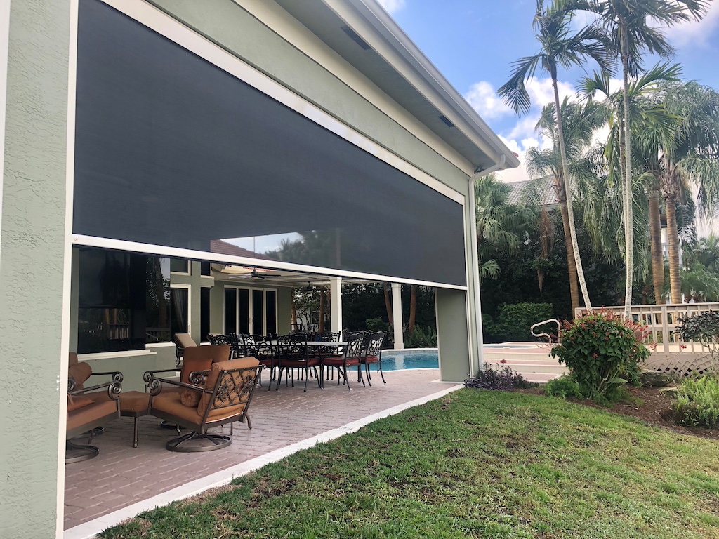 Hurricane-resistant screens covering outdoor living spaces.
