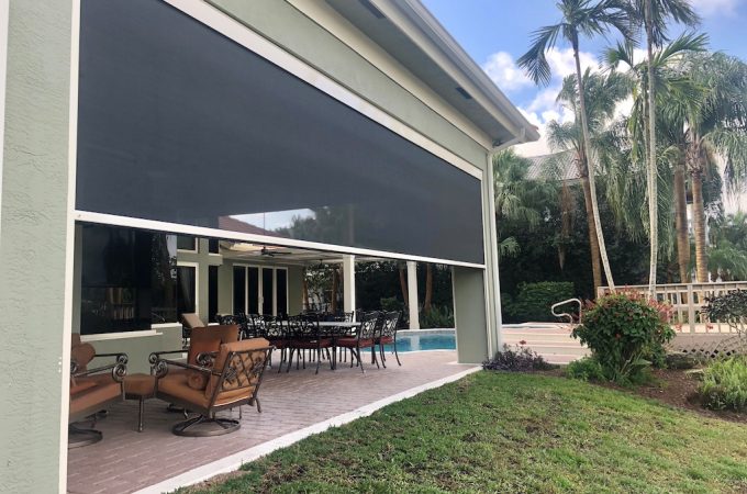 Hurricane-resistant screens covering outdoor living spaces.